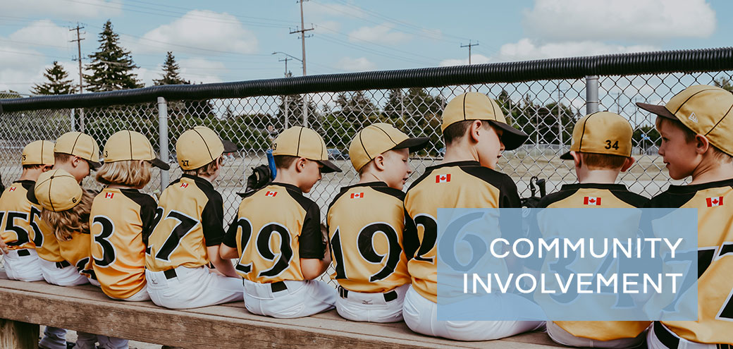 three children in baseball uniforms